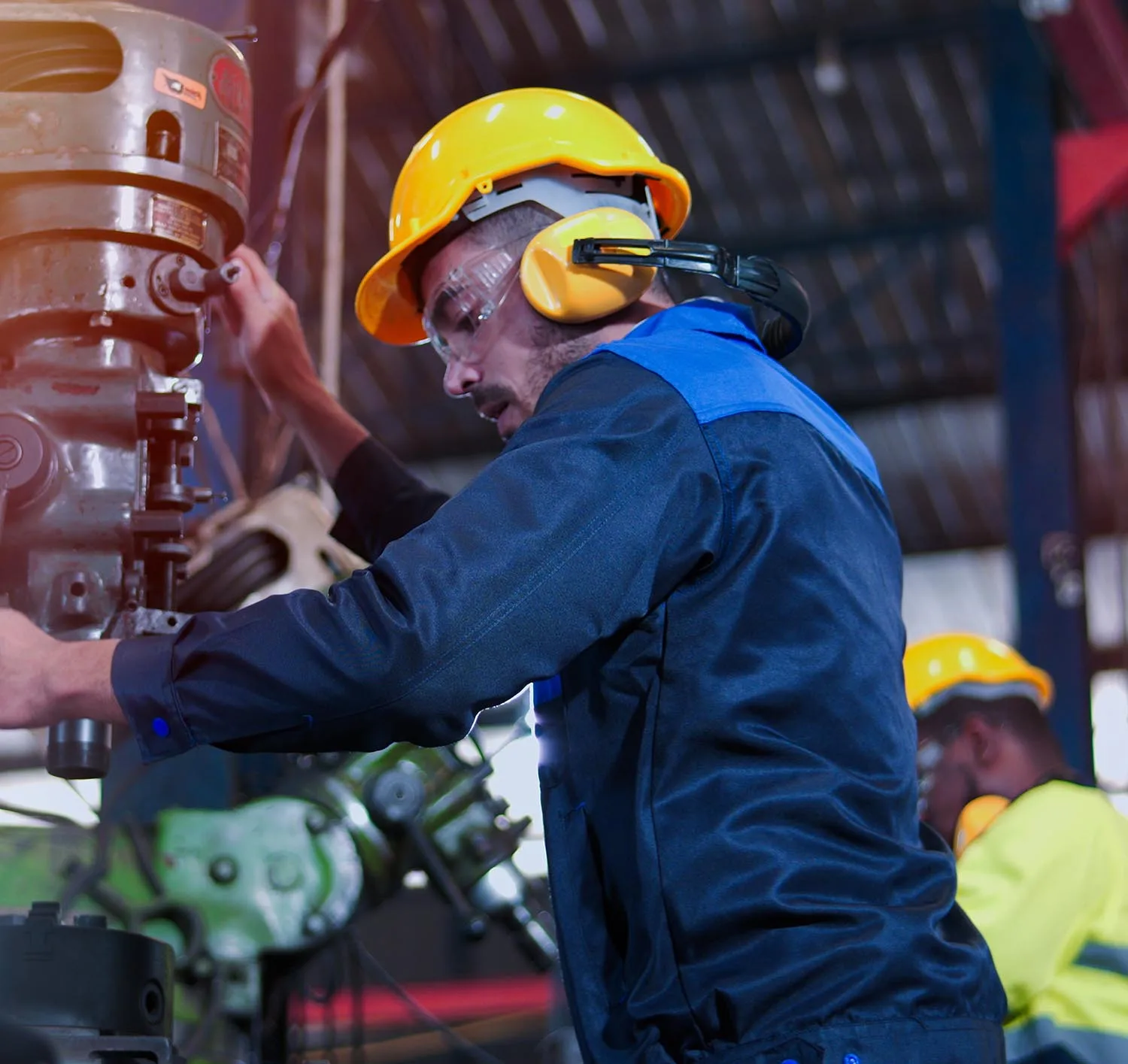 Professional industrial engineer, technician, factory worker wear hard hat, safety glasses. While checking, set up, control machine heavy industry factory. Employee working in manufacturing facility.