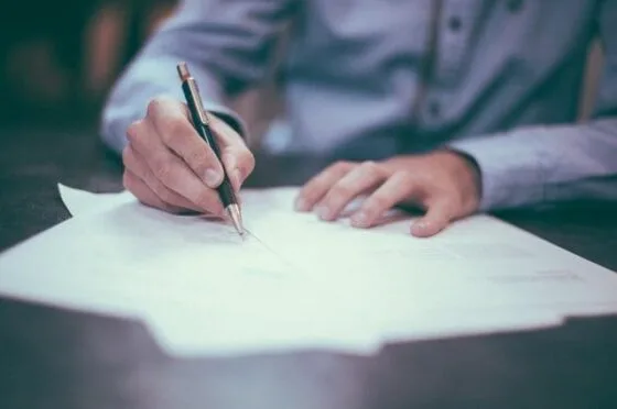 Person signing legal paperwork