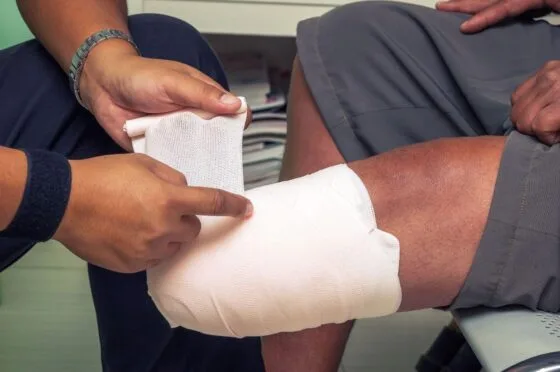 Bandage being wrapped around leg injury