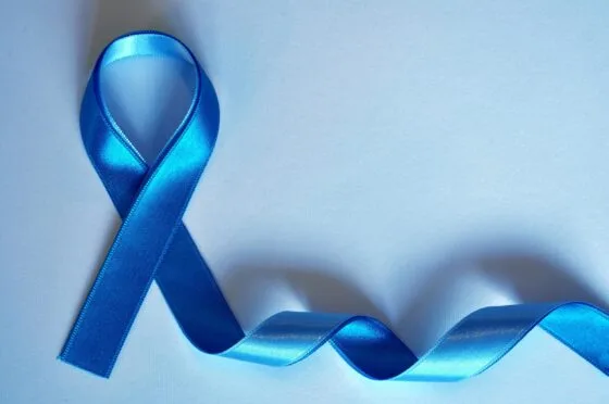 Blue awareness ribbon on blue background