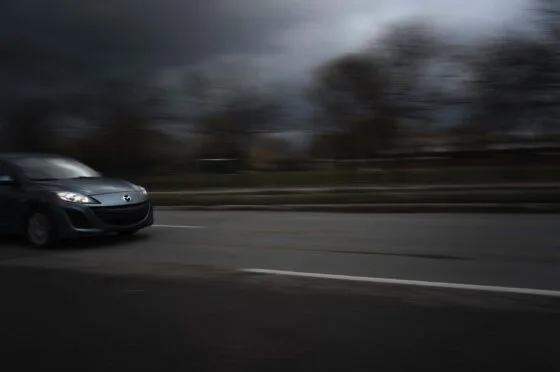 Car driving at speed on road