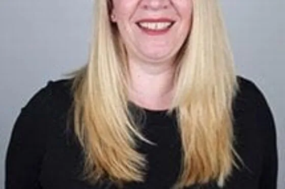Caroline smiling in professional headshot