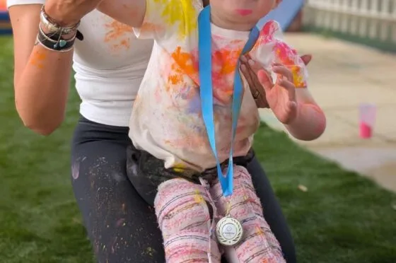 Child using supportive walker outdoors