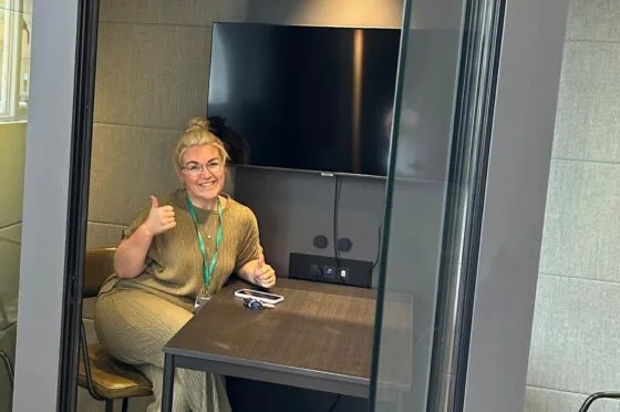 Chloe Sweeney seated in office meeting room