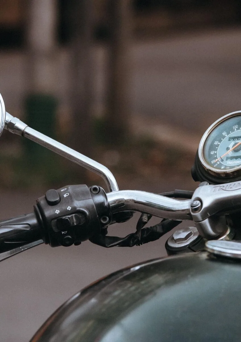 Close-up of motorcycle handlebars and mirror