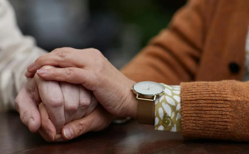 Close-up of one person comforting another