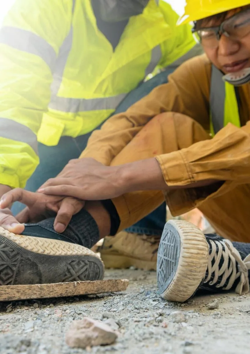 Construction workers helping injured colleague