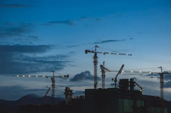 Cranes over construction site at dusk