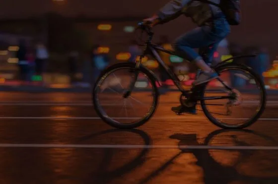 Cyclist riding through city at night