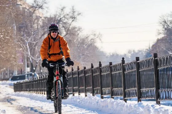 Cyclist riding through snow