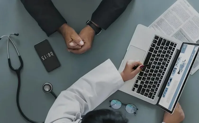 Doctor reviewing medical notes at consultation
