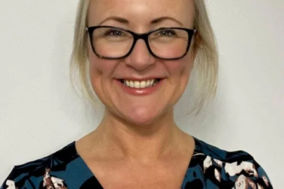 Dr JW smiling in professional headshot
