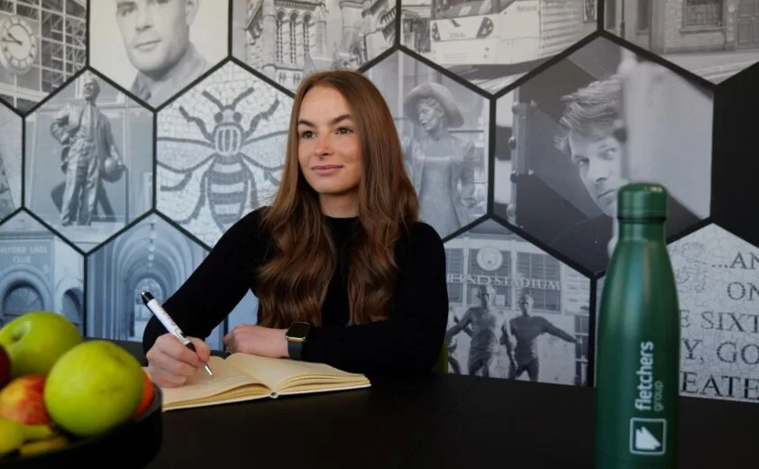 Emily Simpson writing at desk