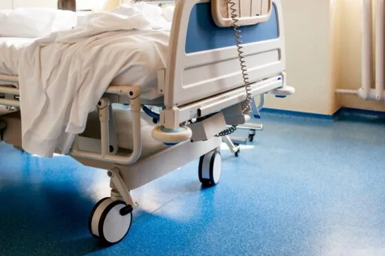 Empty hospital bed on ward