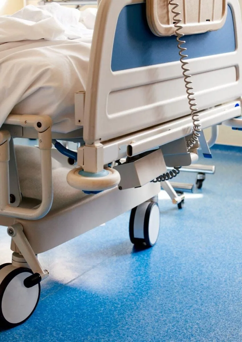 Empty hospital bed on ward