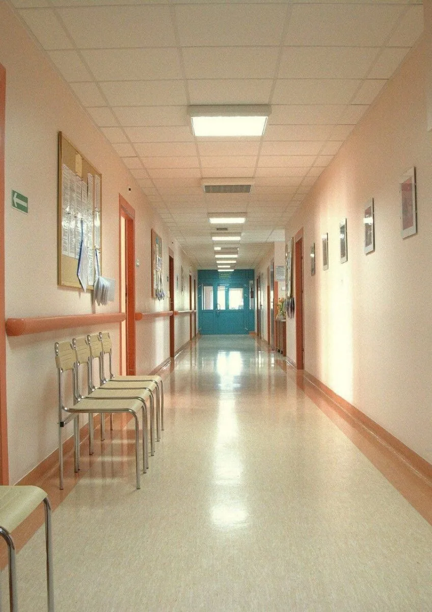 Empty hospital corridor with chairs