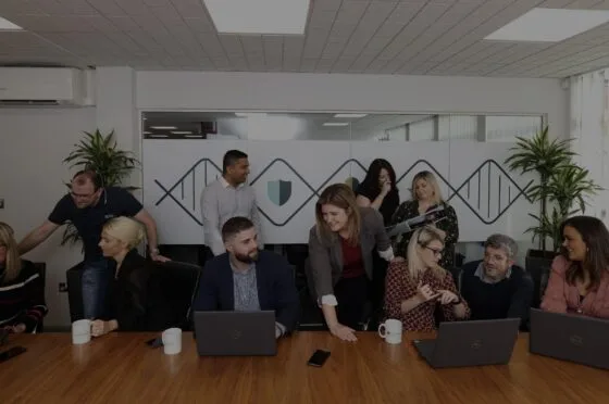 Fletchers team gathered around conference table
