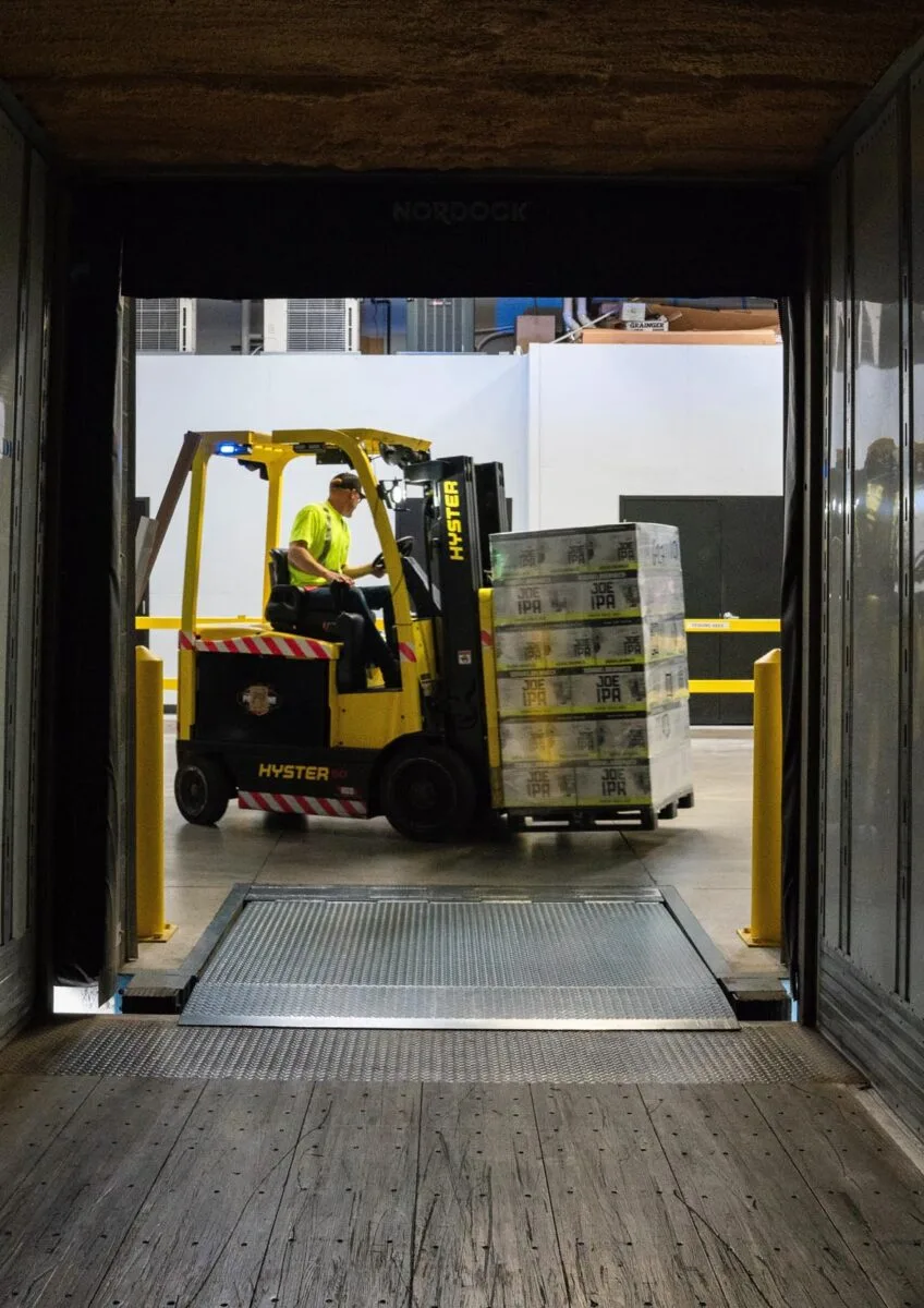 Forklift loading pallets inside lorry