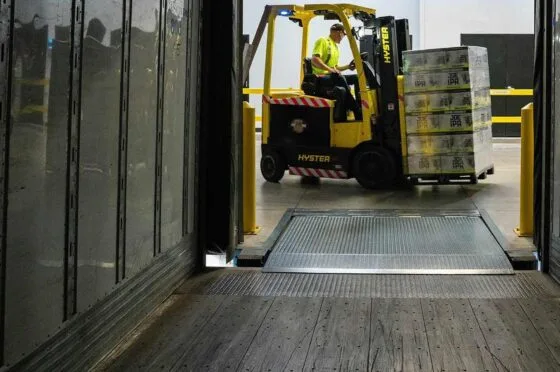 Forklift loading pallets inside warehouse