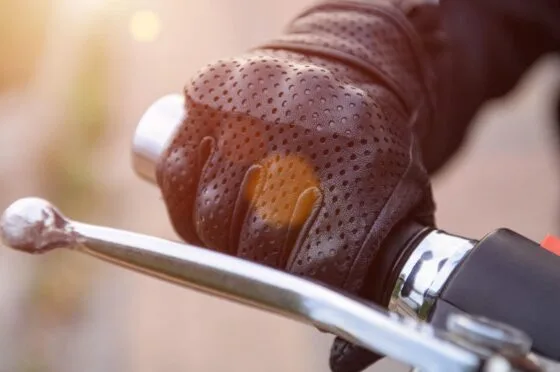 Gloved hand on motorcycle brake lever