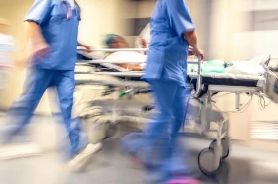 Hospital staff rushing patient on trolley