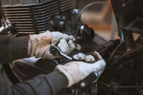 Mechanic repairing motorcycle engine