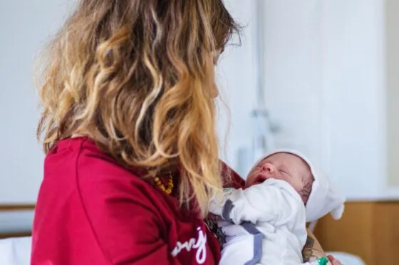 Mother holding newborn baby in hospital