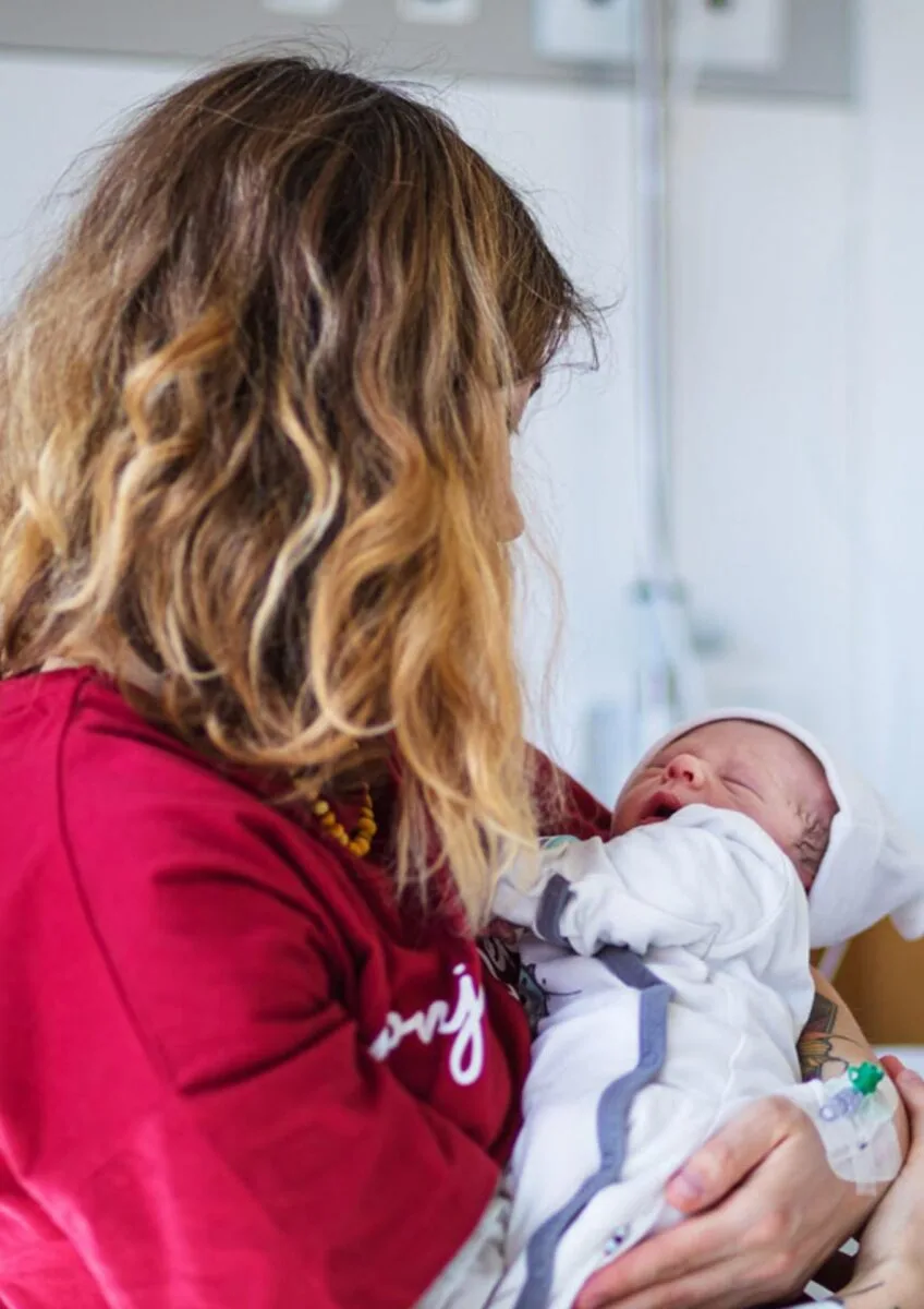 Mother holding newborn baby in hospital