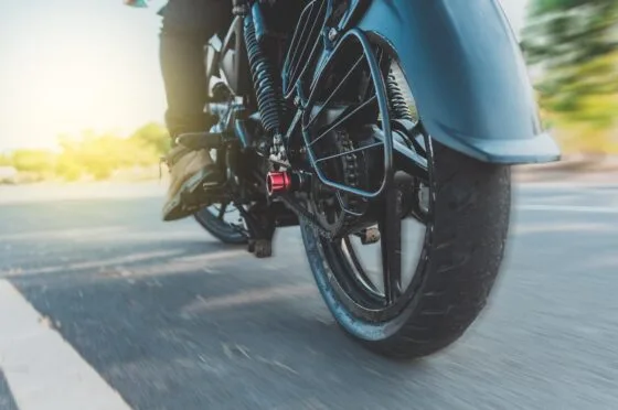 Motorcycle wheel moving along road