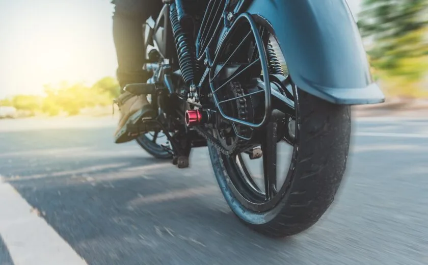 Motorcycle wheel moving along road