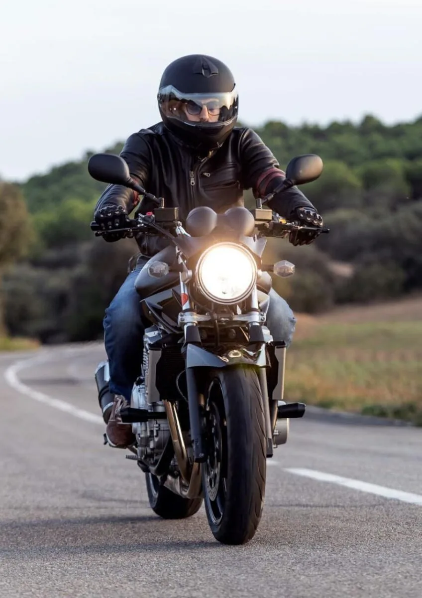Motorcyclist riding on rural road