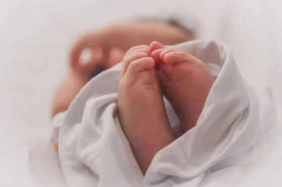 Newborn baby's feet wrapped in blanket