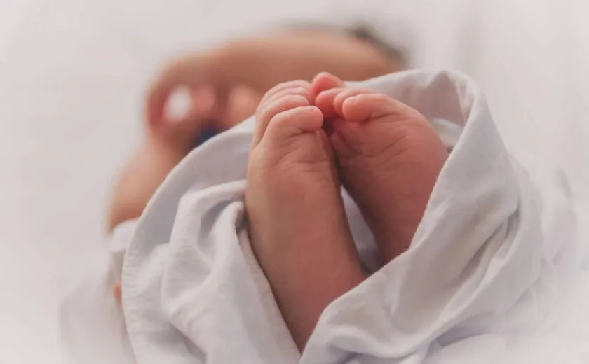 Newborn baby's feet wrapped in blanket