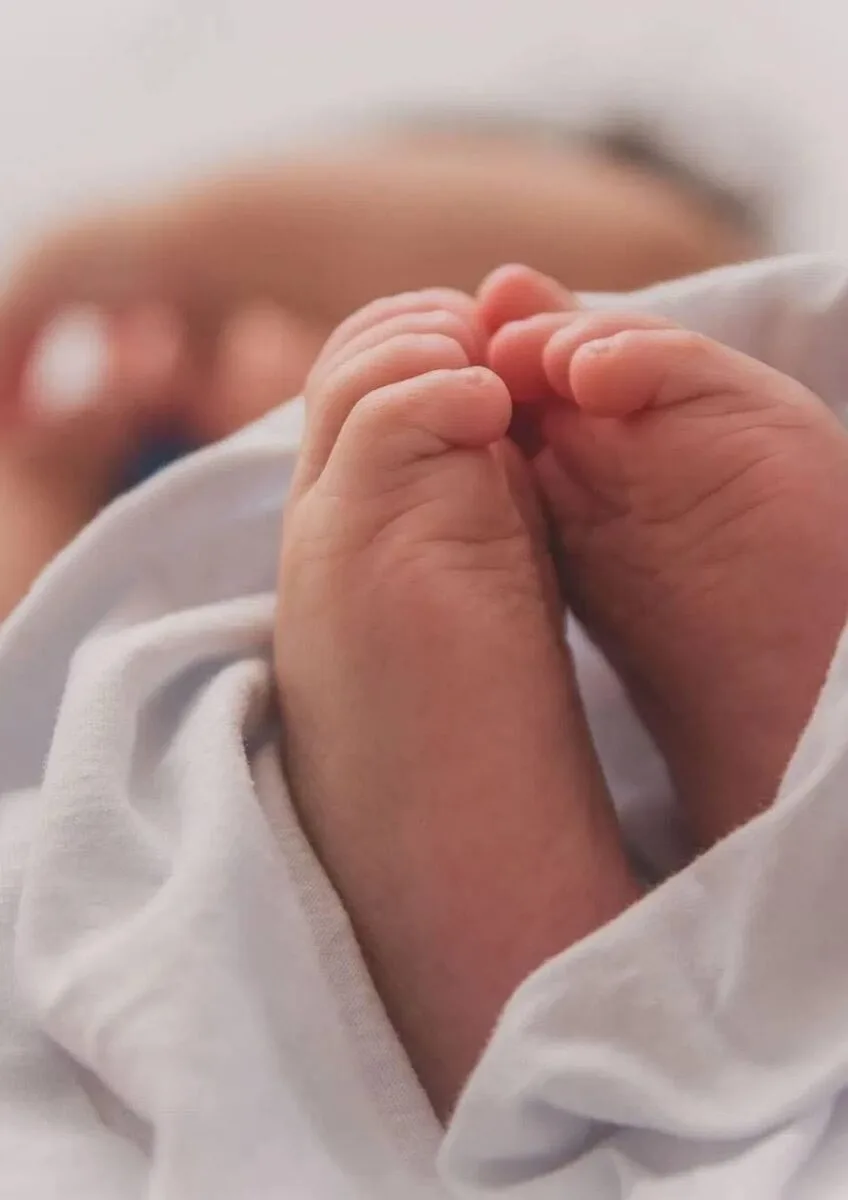 Newborn baby's feet wrapped in blanket