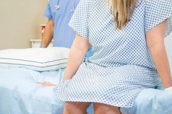 Patient sitting on hospital bed