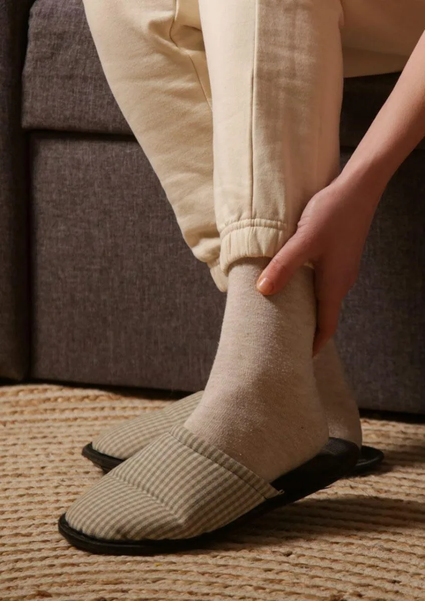 Person holding ankle after fall at home