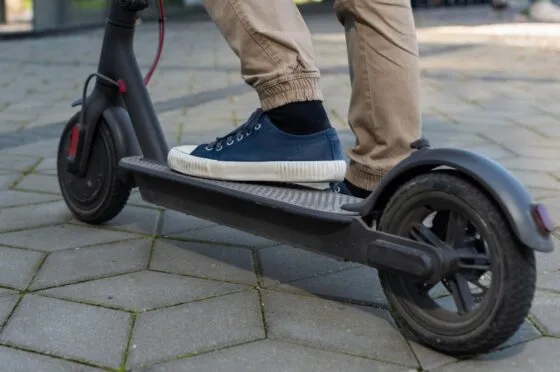 Person riding electric scooter on pavement