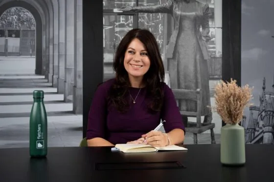 Sarah Samuels writing at desk