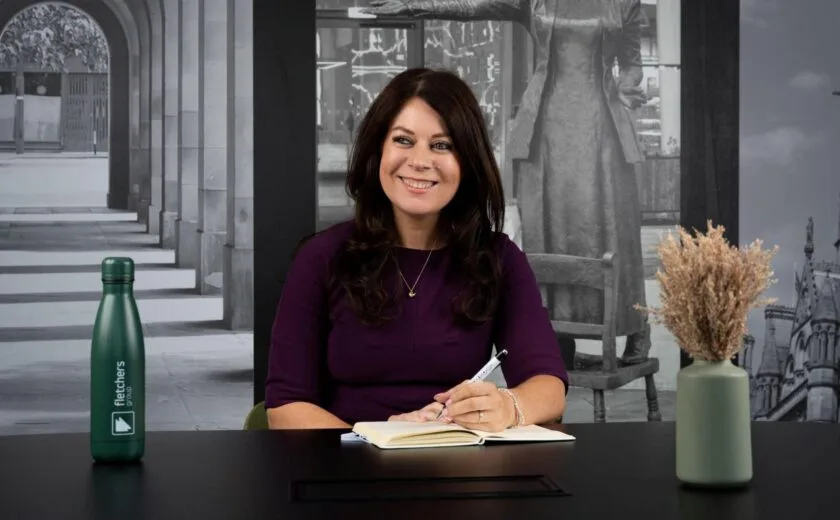 Sarah Samuels writing at desk
