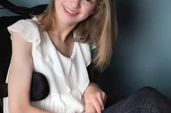 Smiling young woman seated in wheelchair