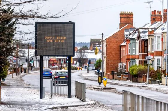 Snowy road with drink-drive warning sign