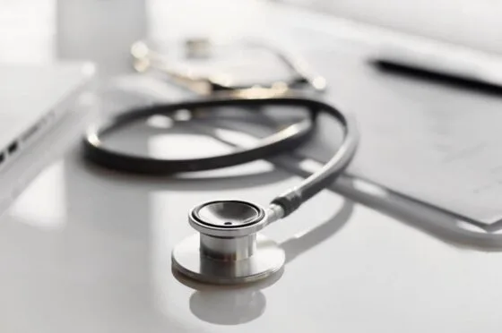 Stethoscope and laptop on medical desk