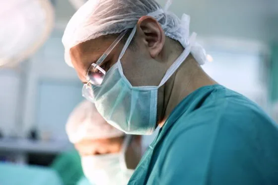 Surgeon wearing mask in operating theatre