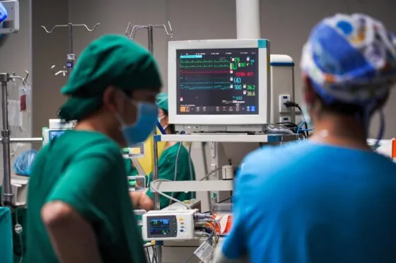 Surgeons monitoring patient in operating theatre