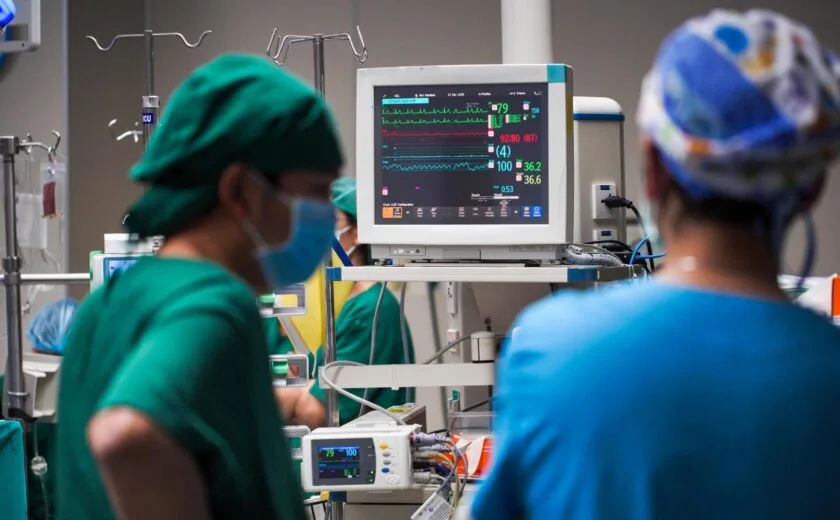 Surgeons monitoring patient in operating theatre