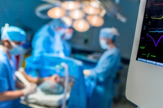 Surgeons operating in hospital theatre