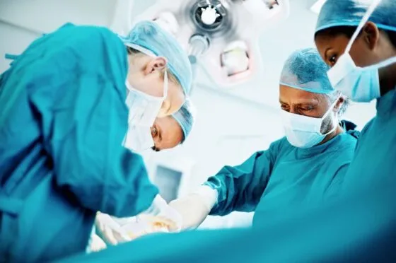 Surgeons operating in theatre