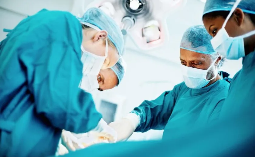 Surgeons operating in theatre