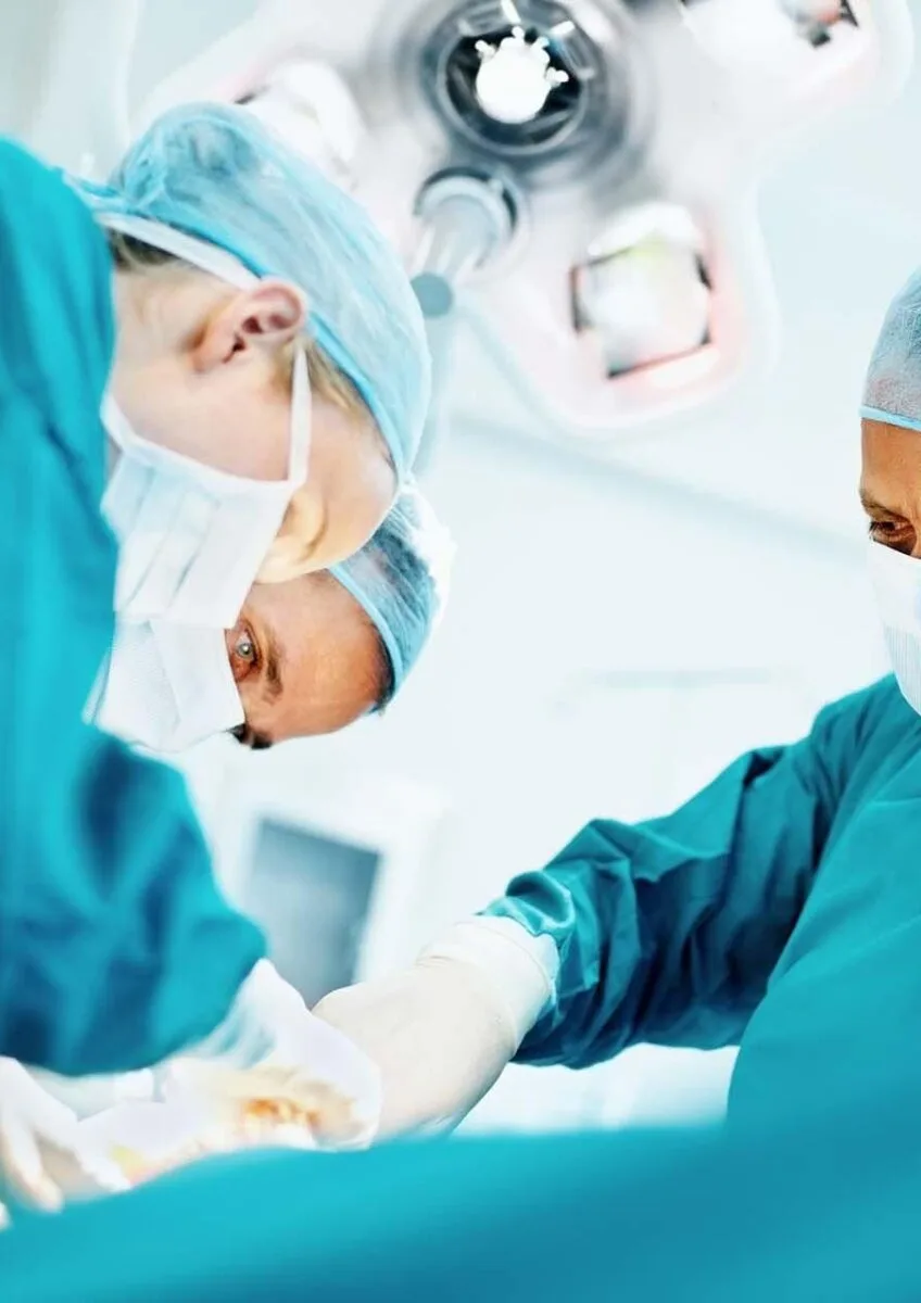 Surgeons operating in theatre