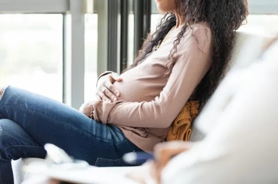 Woman holding pregnant belly